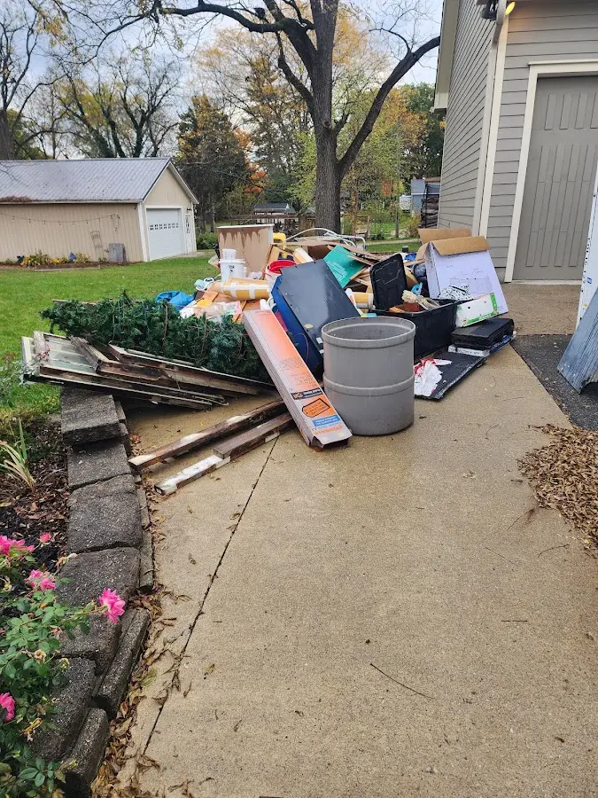 Dumpster being loaded with debris for 10 Yard Dumpster Rental in Eden Prairie